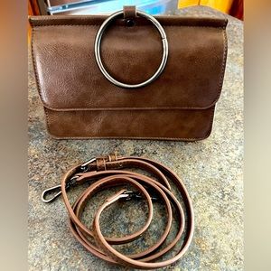 Clutch with metal wrist ring